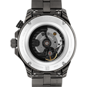Titan 10076QM01 men's Vetra automatic watch with black dial and grey stainless steel strap, exhibition caseback showing the automatic movement