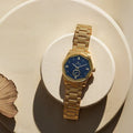 Titan 1749YM01 Quartz Analog Watch with Blue Dial and Gold Stainless Steel Strap for Men