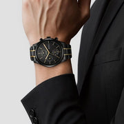 Titan 1805KM06 black dial watch with black stainless steel strap and gold-tone accents, watch worn on wrist