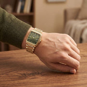 Titan 90260YM01 green dial watch with gold strap, watch shown worn on the wrist