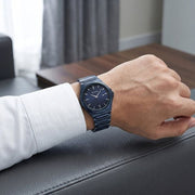 Titan 90261QM01 blue dial watch with blue strap, watch shown worn on the wrist